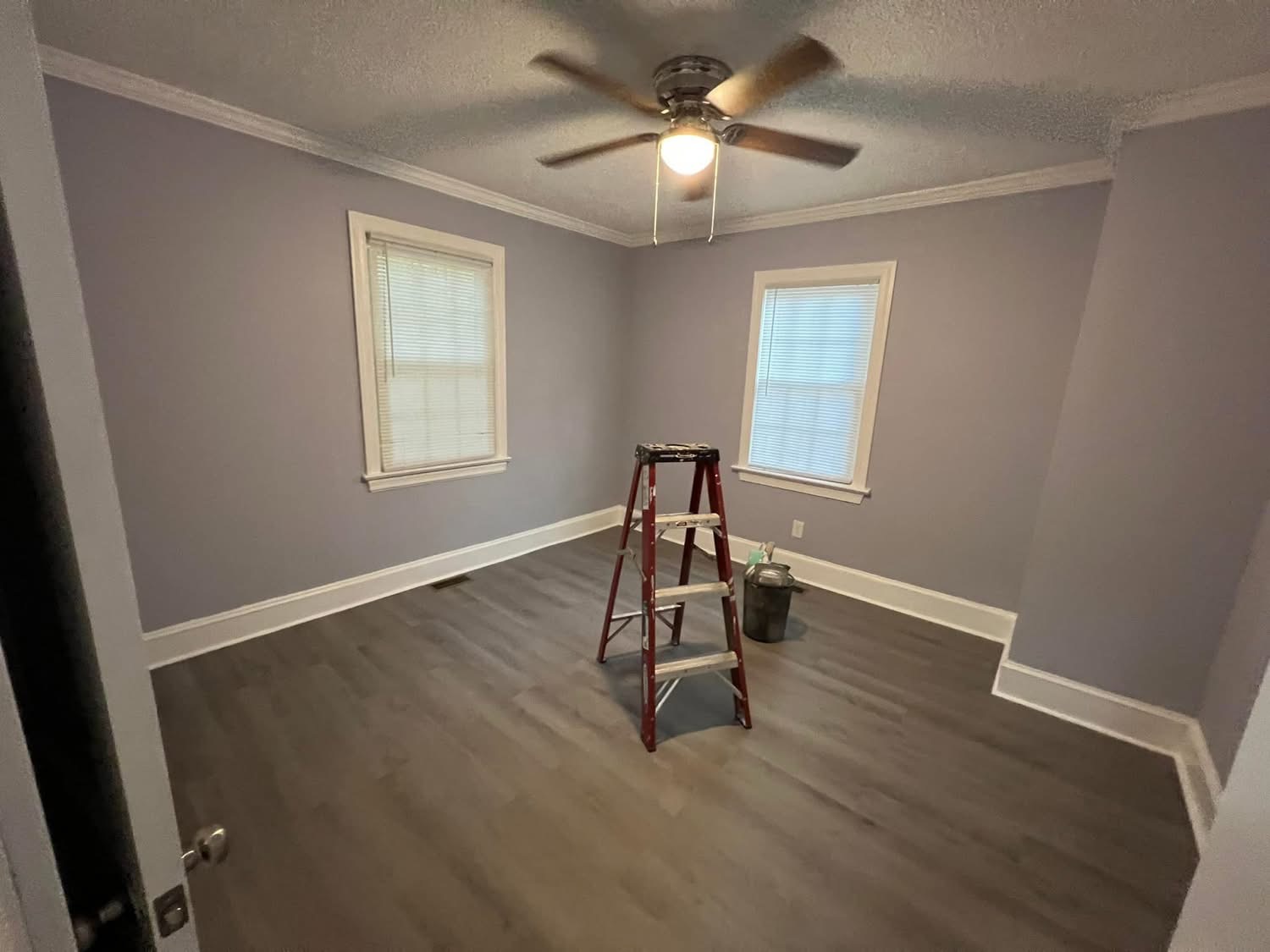 Room after renovation with gray walls, trim, and finished flooring